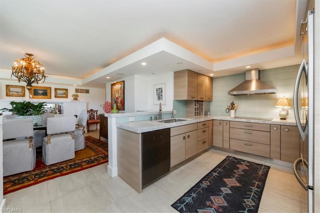 107 Clubhouse Lane, Unit 391 Naples, FL 34105 - Photo 5 of 37 a kitchen with sink cabinets and window