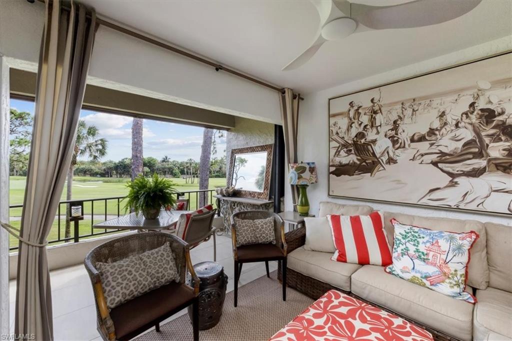 107 Clubhouse Lane, Unit 391 Naples, FL 34105 - Photo 6 of 37 a living room with furniture and a large window