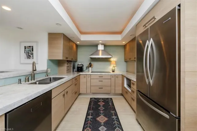 a kitchen with a sink stainless steel appliances and cabinets