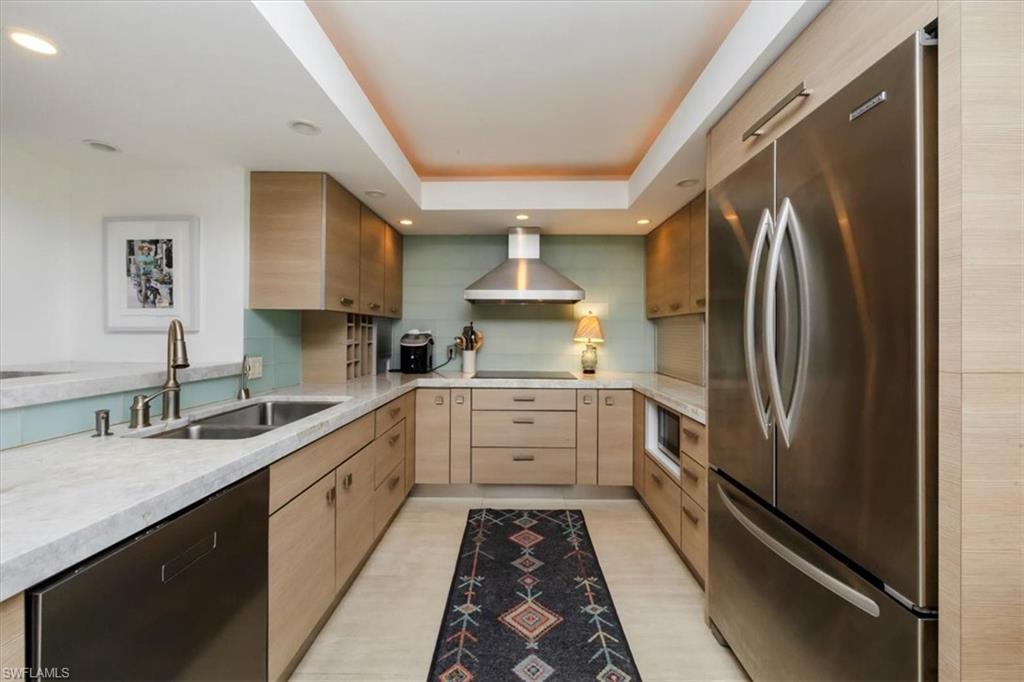 107 Clubhouse Lane, Unit 391 Naples, FL 34105 - Photo 7 of 37 a kitchen with a sink stainless steel appliances and cabinets