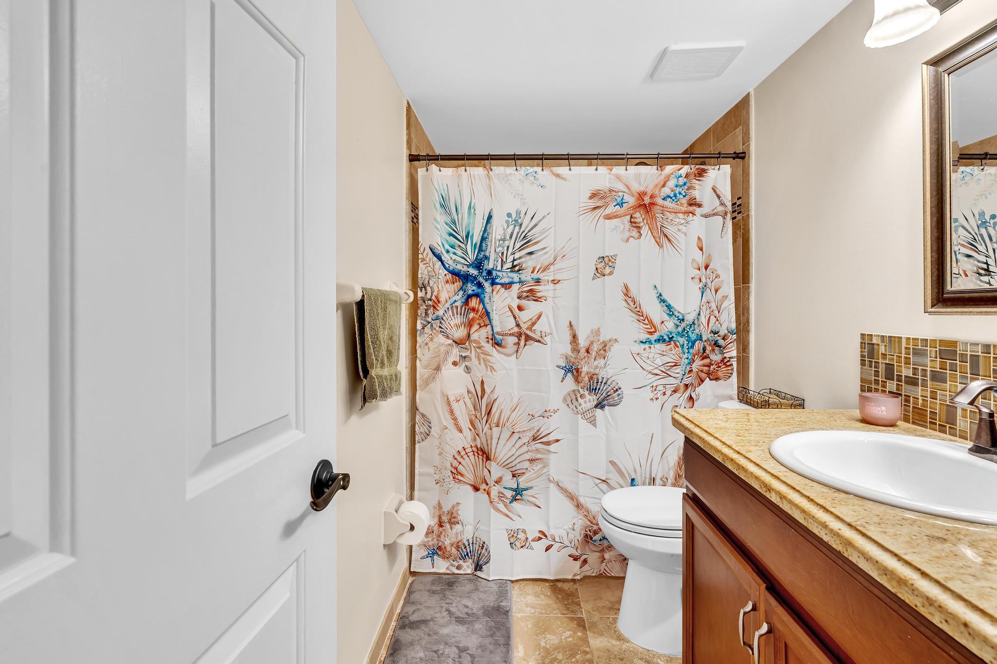 17372 Boca Club Boulevard, Unit 405 Boca Raton, FL 33487 - Photo 49 of 74 a bathroom with a granite countertop sink a mirror and a shower curtain