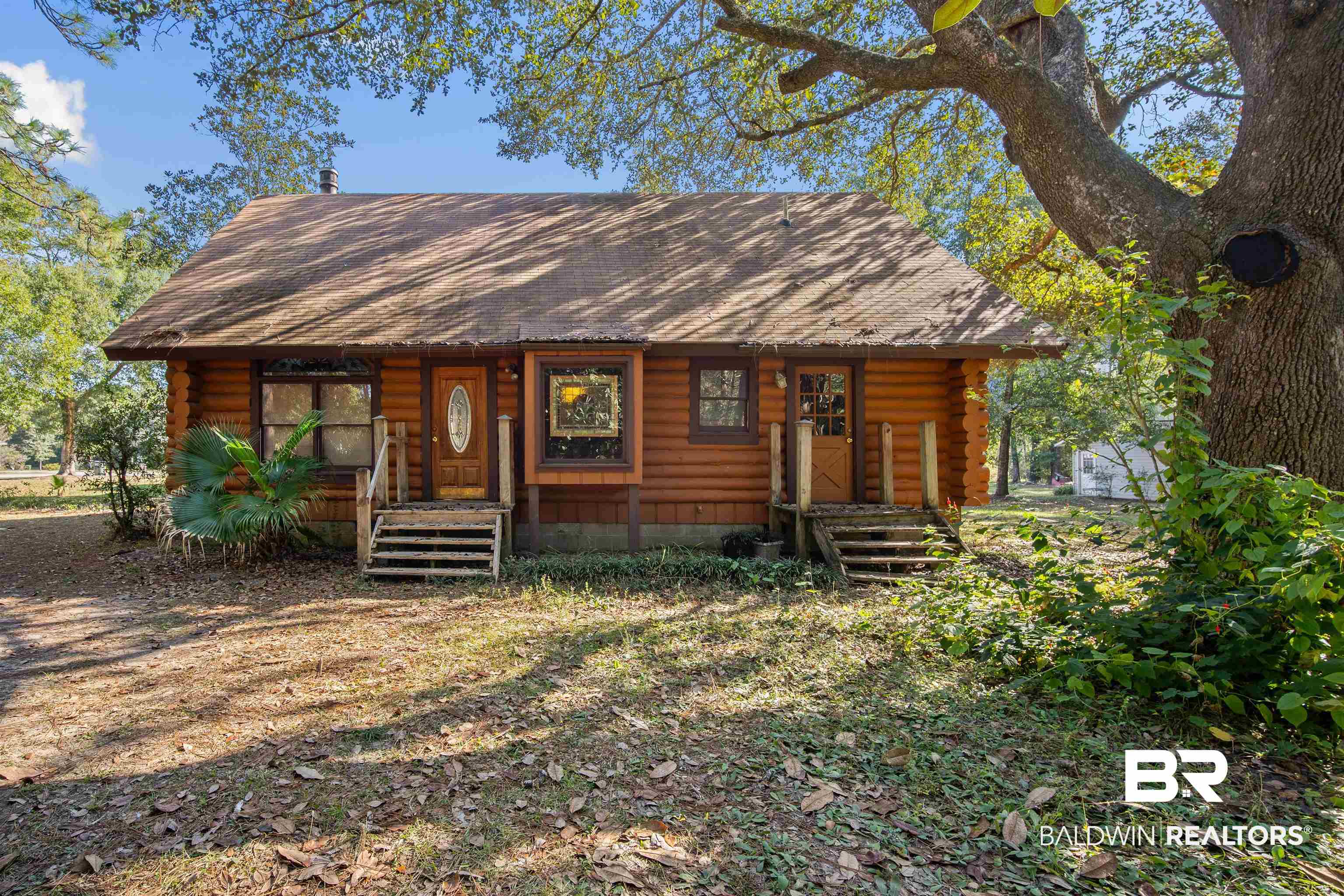 11236 Wren Avenue Fairhope, AL 36532 - Photo 1 of 35 View of front of house featuring log siding and roof with shingles
