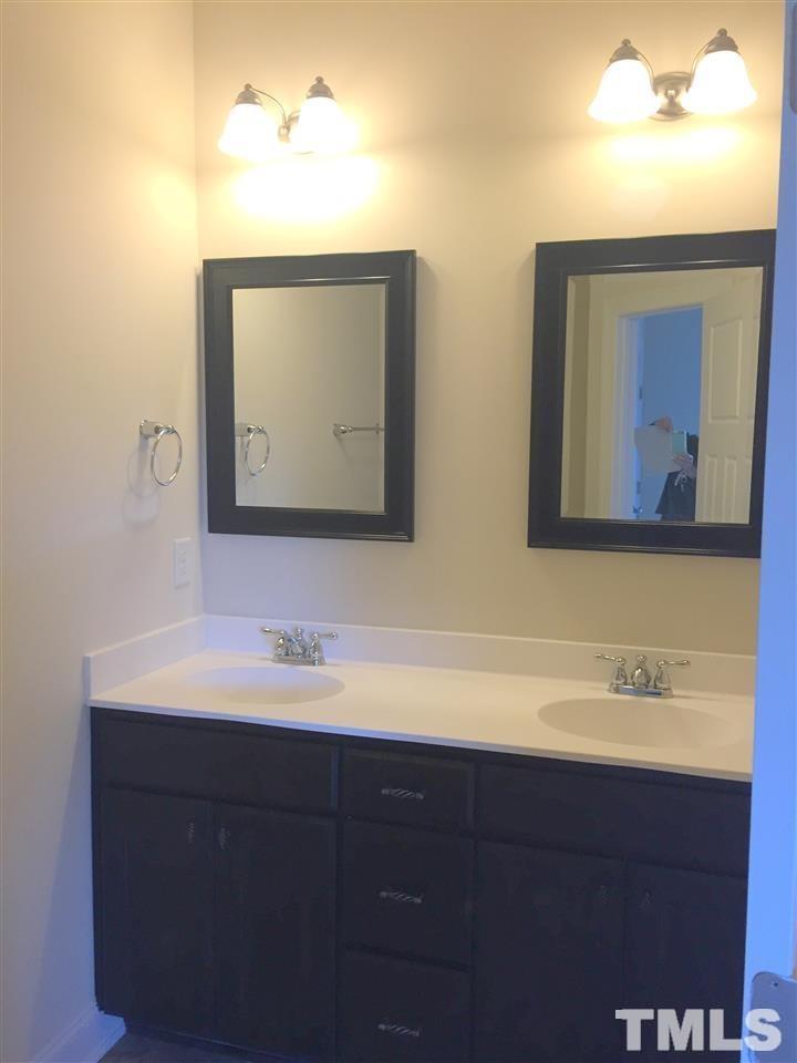 3950 Amelia Park Drive Raleigh, NC 27606 - Photo 11 of 20 a bathroom with a toilet sink and mirror