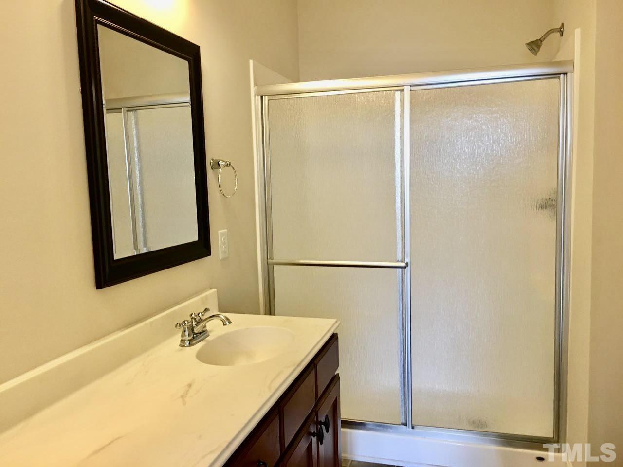 3950 Amelia Park Drive Raleigh, NC 27606 - Photo 12 of 20 a bathroom with a sink and mirror