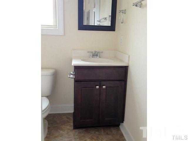 3950 Amelia Park Drive Raleigh, NC 27606 - Photo 13 of 20 a bathroom with a sink and a mirror