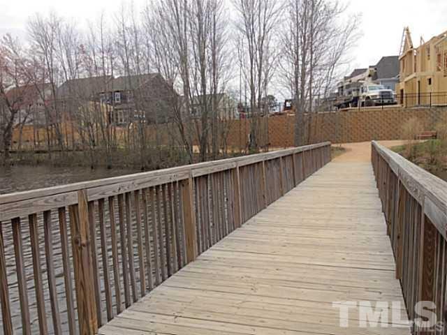3950 Amelia Park Drive Raleigh, NC 27606 - Photo 17 of 20 a balcony with wooden floor and fence
