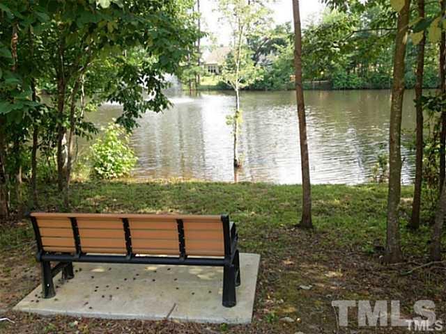 3950 Amelia Park Drive Raleigh, NC 27606 - Photo 19 of 20 a view of a bench in a garden near a lake