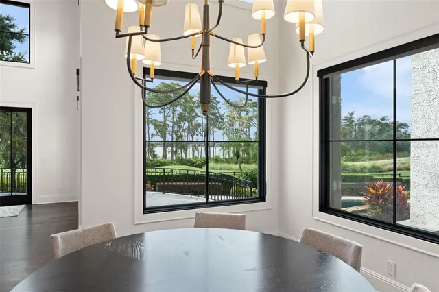 a large white kitchen with a large window a counter space and stainless steel appliances
