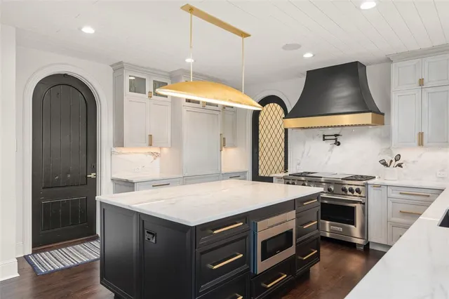 a kitchen that has a stove and a table