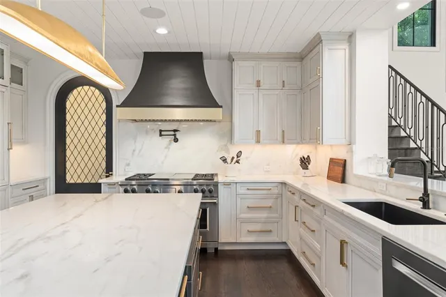 a kitchen with a stove and a white cabinet