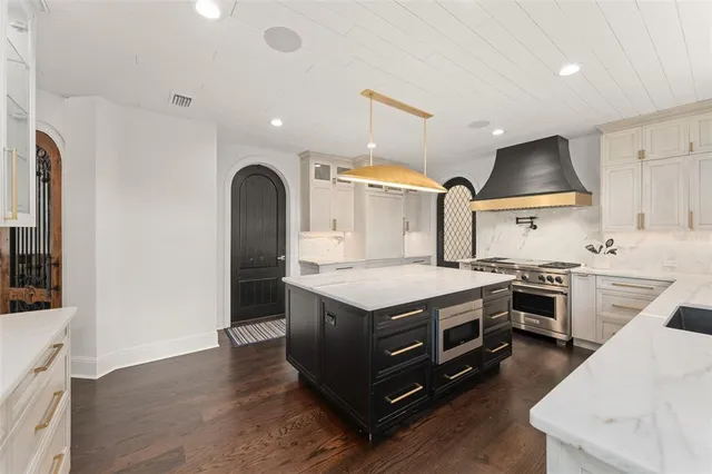 a view of a livingroom with wooden floor and a mirror