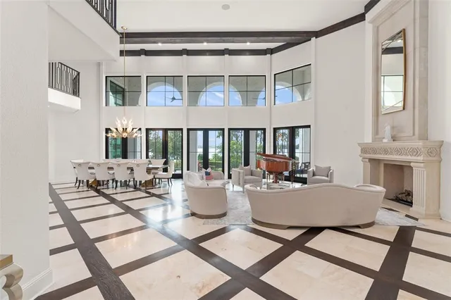 a living room with furniture a fireplace and a large window