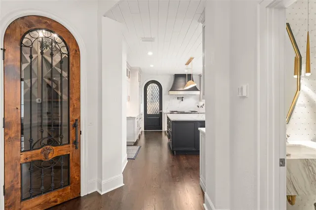 a bedroom with a large window and a wooden floor