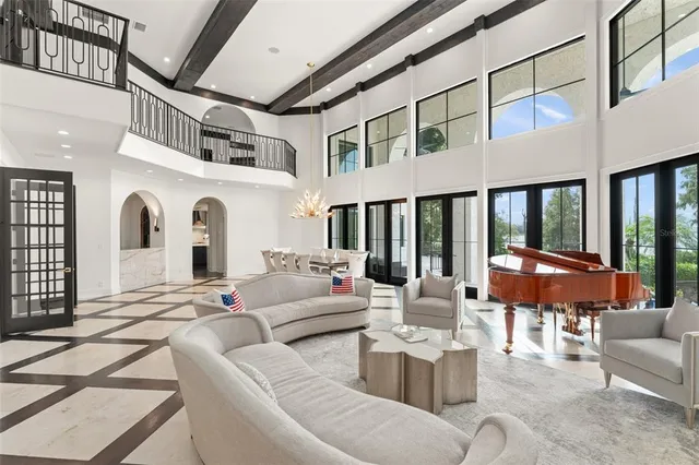 a view of a dining room with furniture large windows and wooden floor