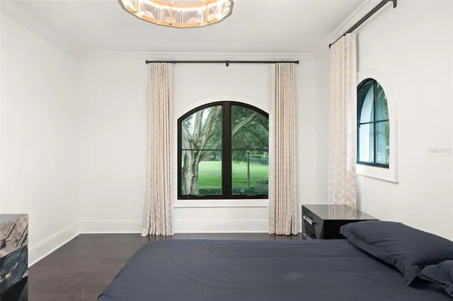 a view of a balcony with potted plants and floor to ceiling window