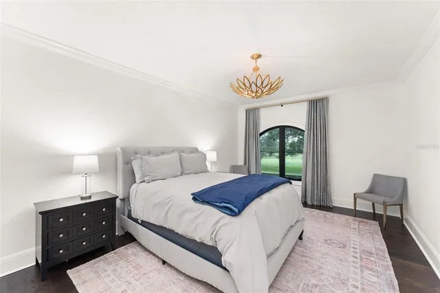 a front view of a house with a yard and potted plants