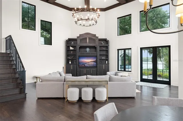 a living room with furniture and a chandelier