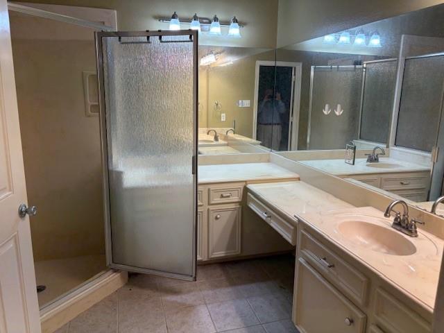 31205 Hegar Road Hockley, TX 77447 - Photo 11 of 17 a bathroom with a granite countertop sink mirror and shower