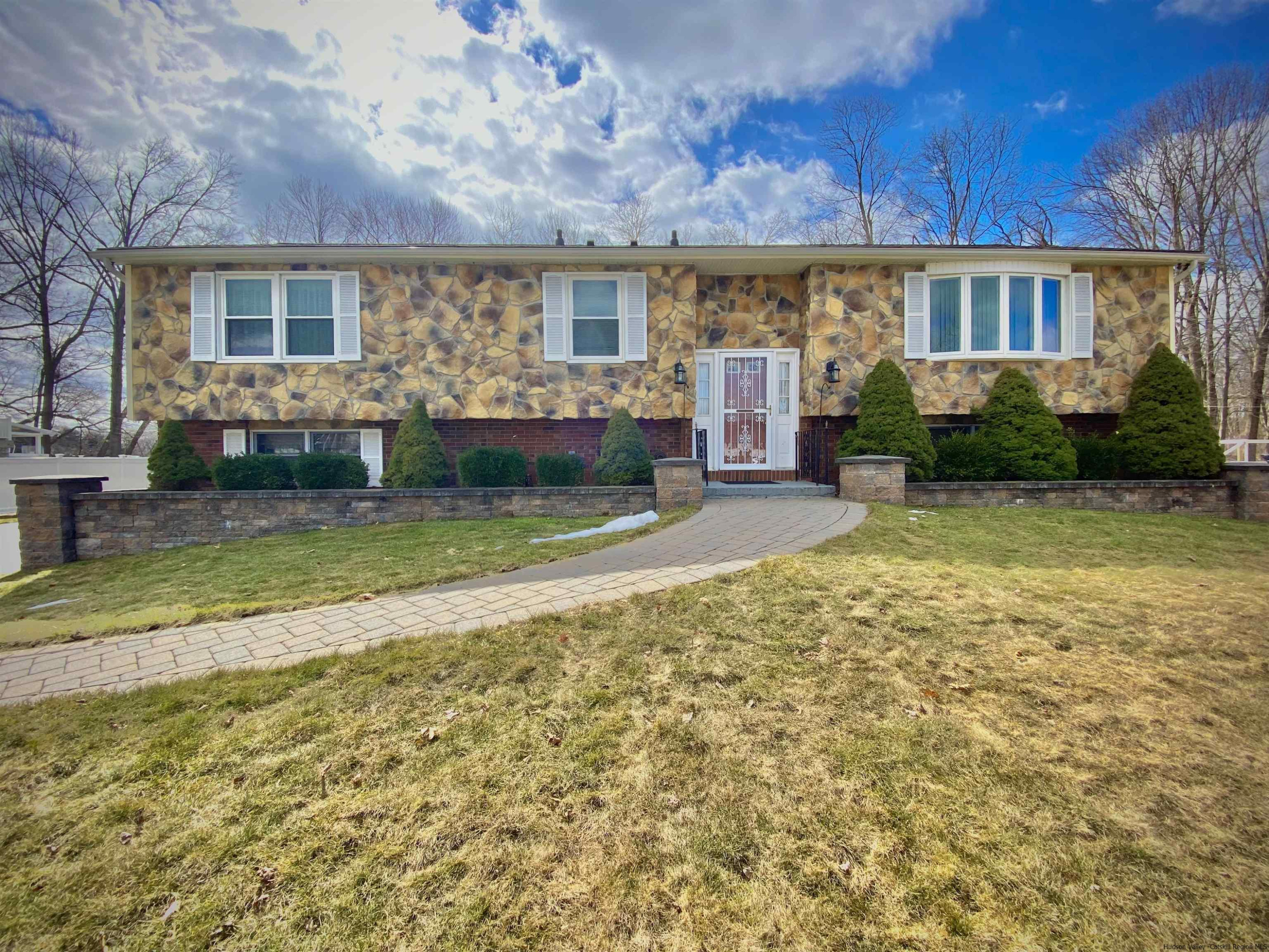 a view of a house with backyard and sitting area