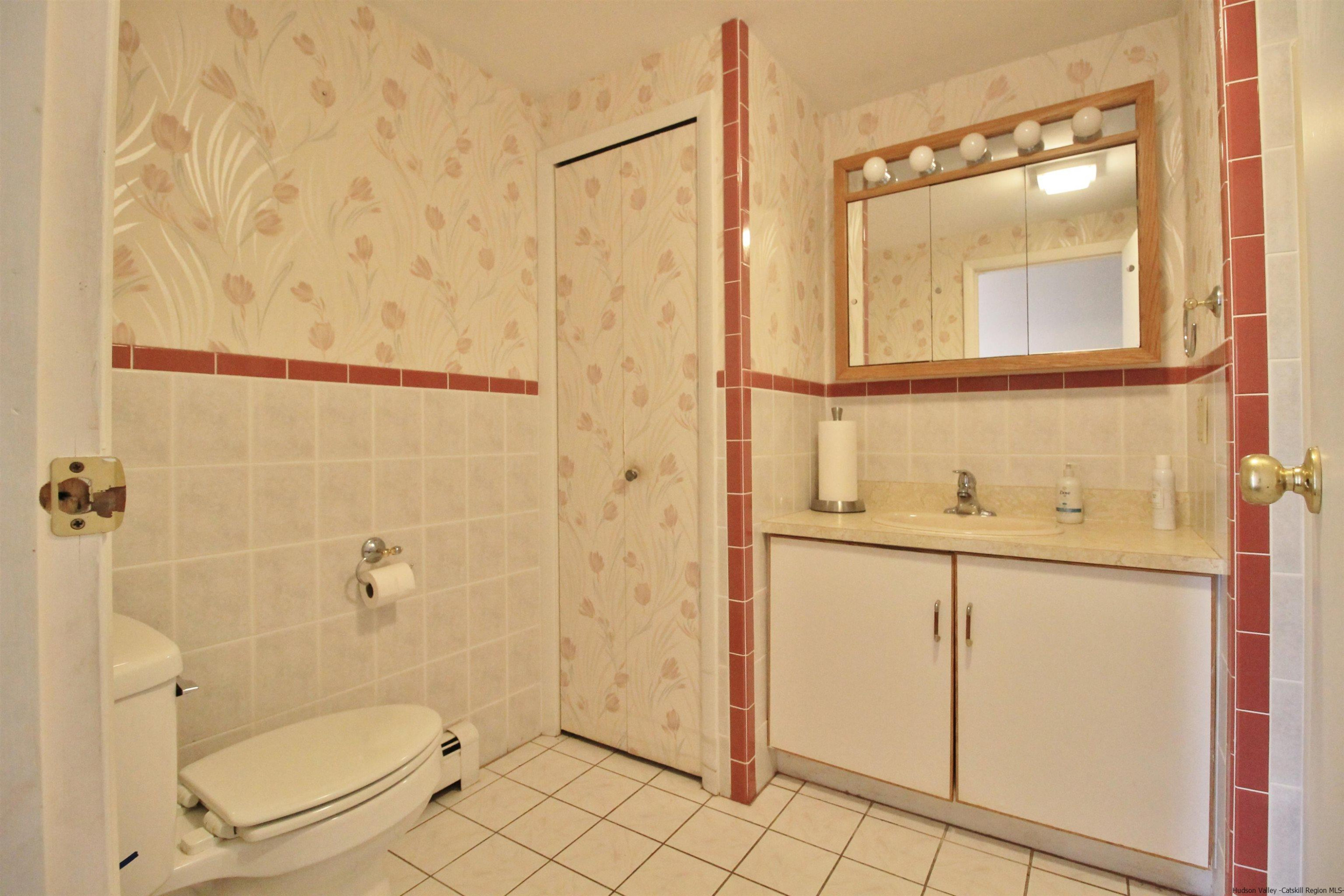 8 Pawan Circle Lake Katrine, NY 12449 - Photo 12 of 28 a bathroom with a granite countertop shower a toilet and a sink