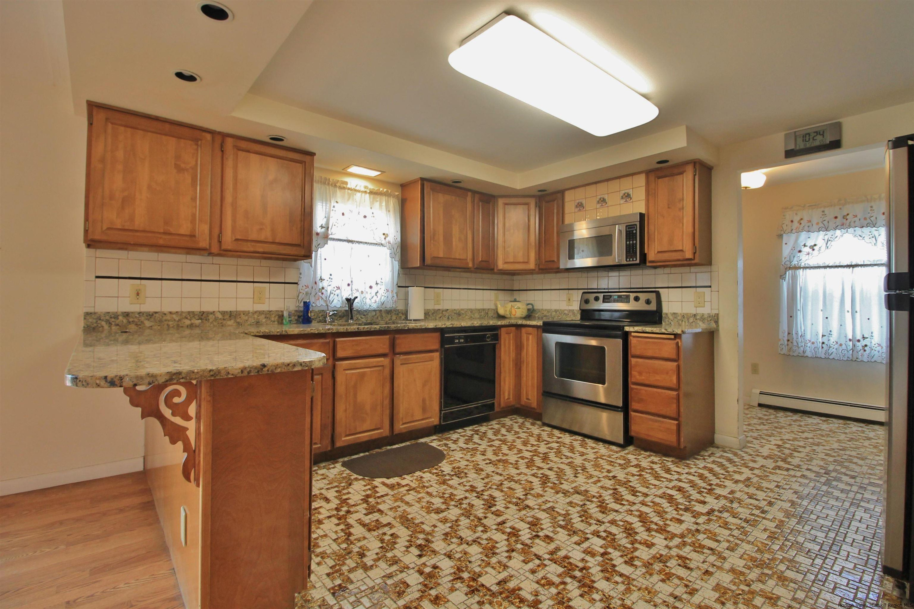8 Pawan Circle Lake Katrine, NY 12449 - Photo 7 of 28 a kitchen with stainless steel appliances granite countertop a stove a sink dishwasher and a refrigerator with wooden cabinets