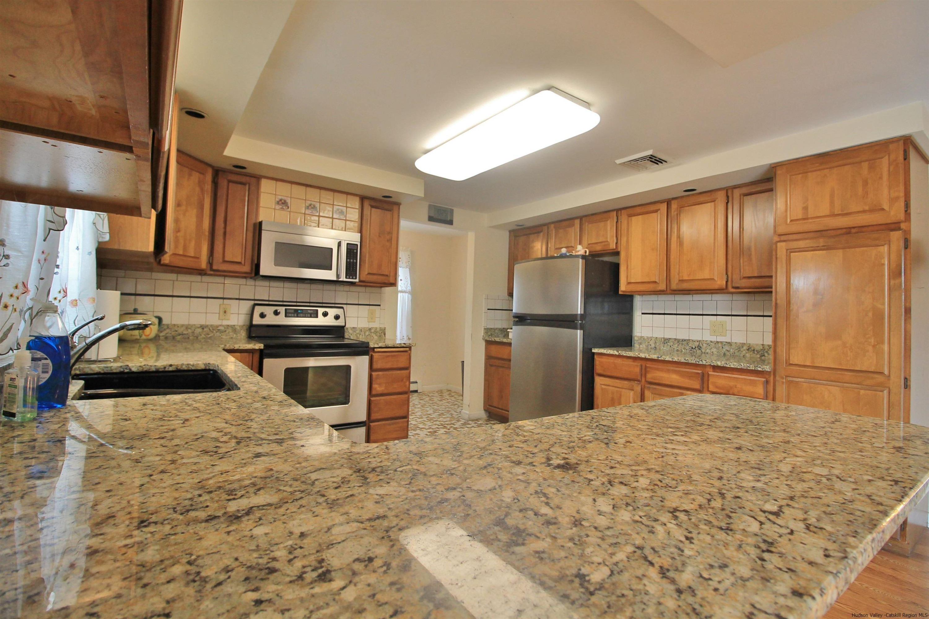 8 Pawan Circle Lake Katrine, NY 12449 - Photo 9 of 28 a kitchen with stainless steel appliances granite countertop a refrigerator a stove and a sink