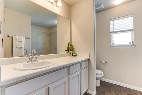 a bathroom with a sink toilet and a mirror
