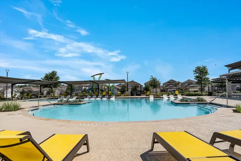 a view of a swimming pool with outdoor seating