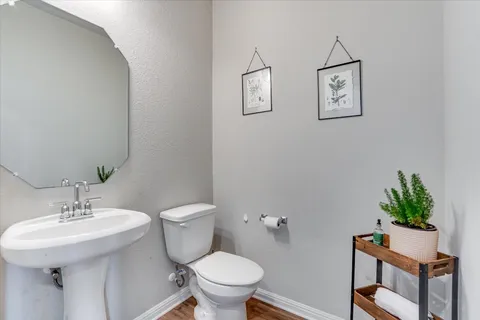 a bathroom with a toilet a sink and mirror