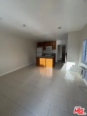 a kitchen with a refrigerator and a sink