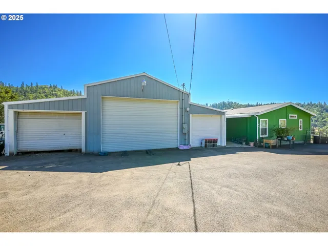a view of a house with a yard and garage
