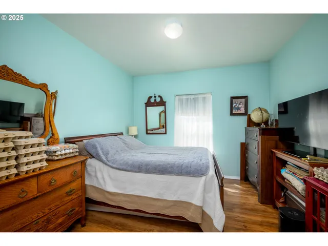 a bedroom with a bed and a flat screen tv