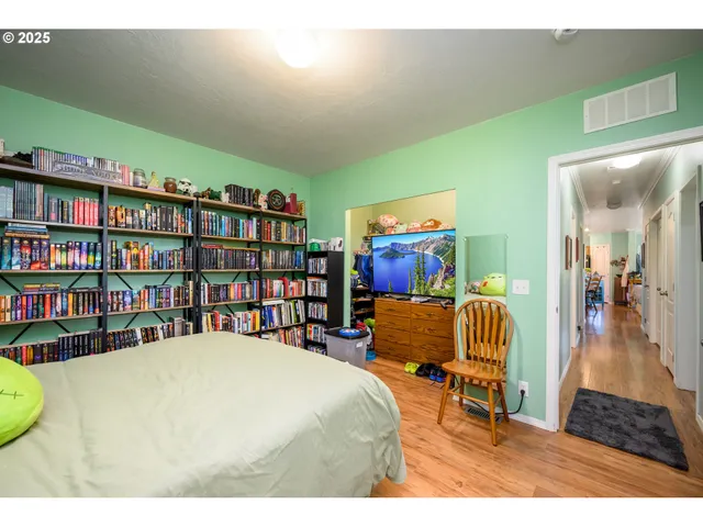 a living room with furniture and a book shelf