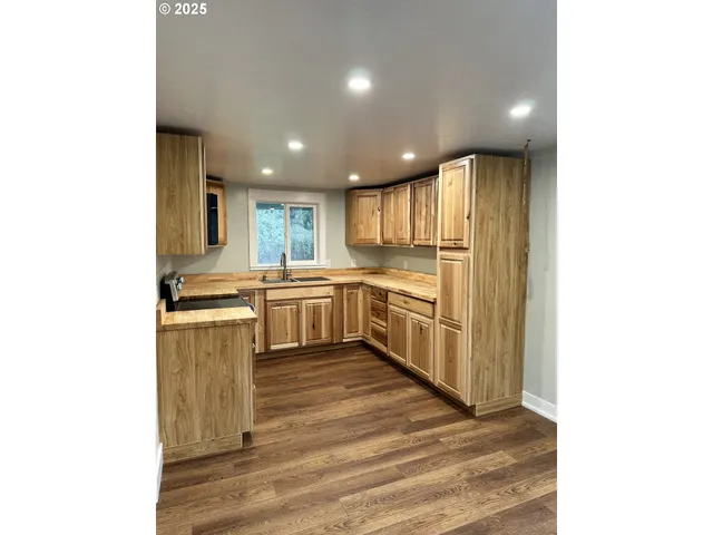 a kitchen with a sink cabinets and stainless steel appliances