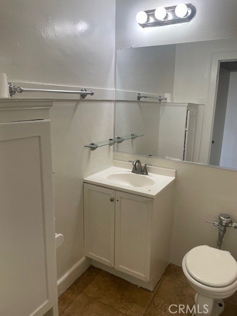 1738 East 4th Street, Unit 1 Long Beach, CA 90802 - Photo 19 of 23 a bathroom with a sink toilet and vanity