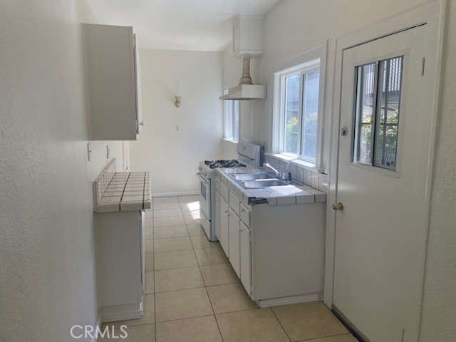 1738 East 4th Street, Unit 1 Long Beach, CA 90802 - Photo 3 of 23 a bathroom with a double vanity sink and mirror