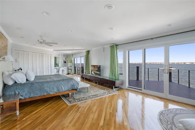 a spacious bedroom with a large bed and a large window