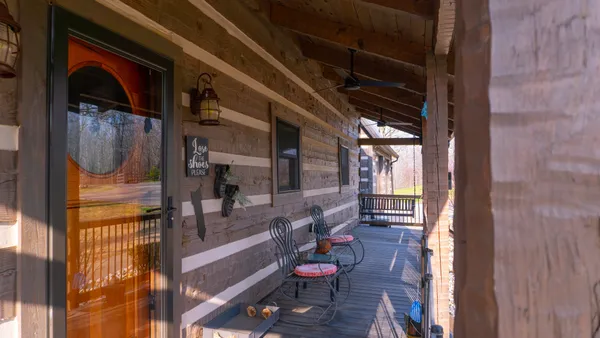 a view of a chairs and table in the balcony