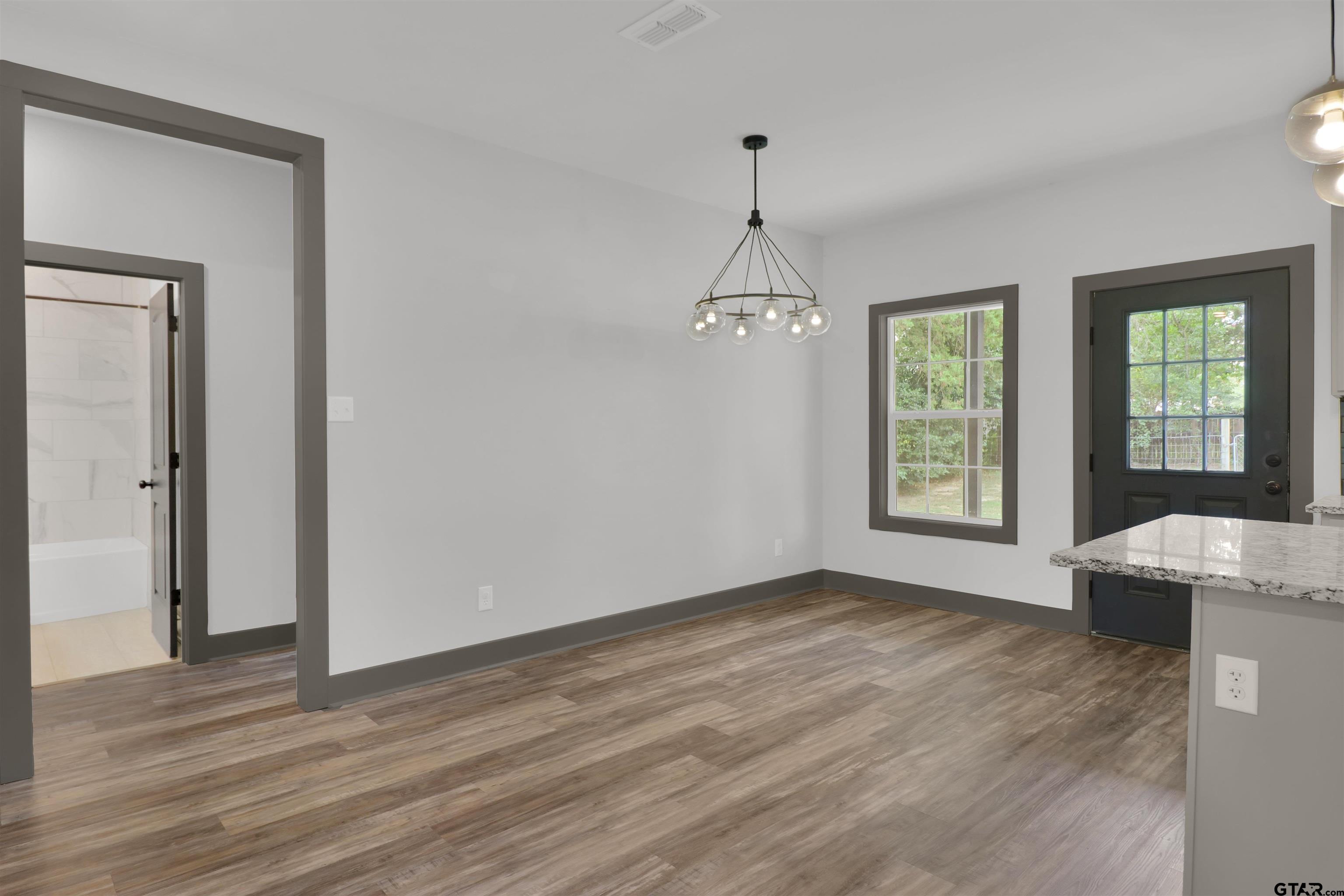 220 Sherman Street Rusk, TX 75785 - Photo 11 of 33 a view of an empty room with window and wooden floor