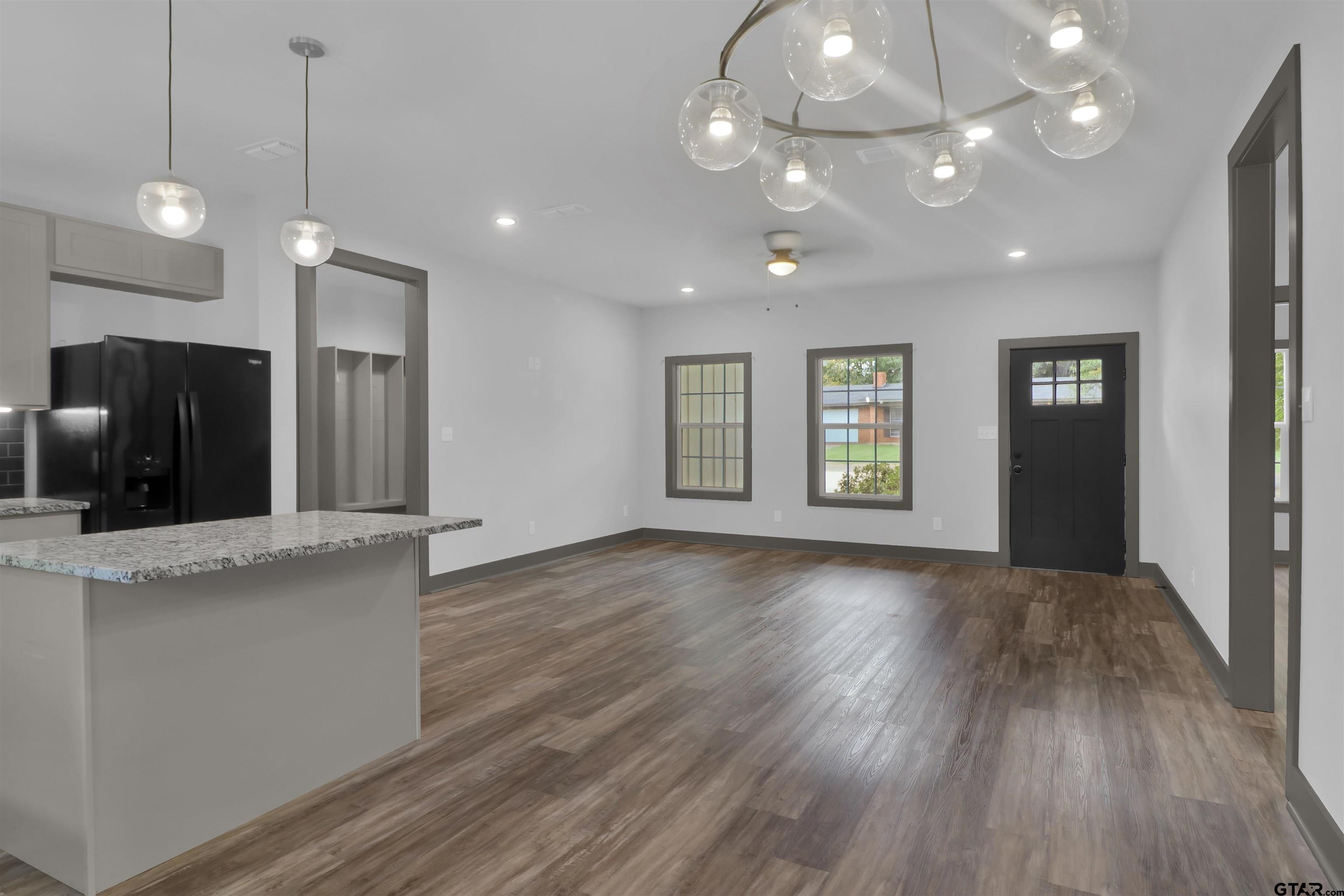 220 Sherman Street Rusk, TX 75785 - Photo 14 of 33 a view of an empty room with window and wooden floor