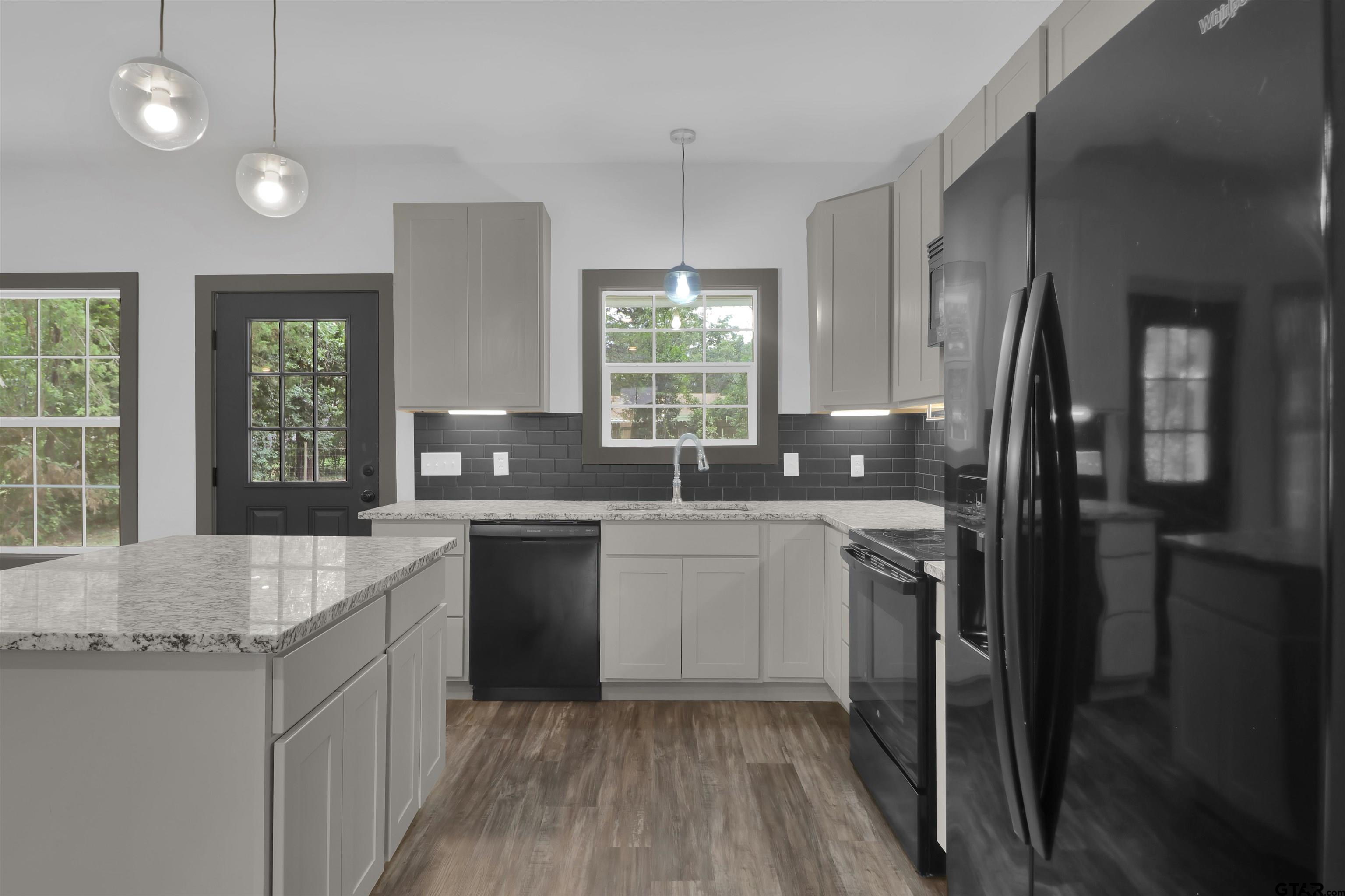 220 Sherman Street Rusk, TX 75785 - Photo 15 of 33 a kitchen with a sink stove and refrigerator