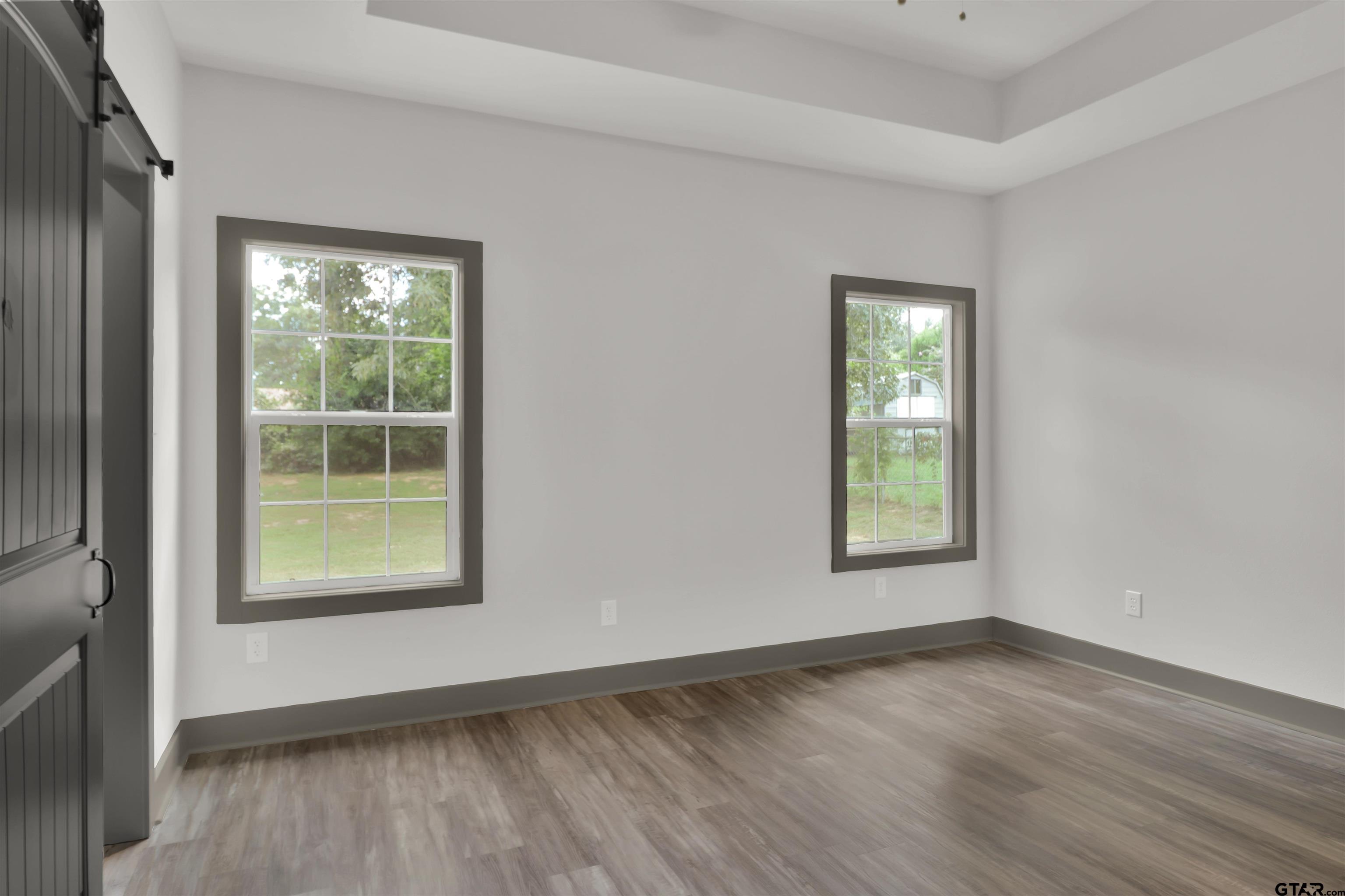 220 Sherman Street Rusk, TX 75785 - Photo 20 of 33 an empty room with wooden floor and windows