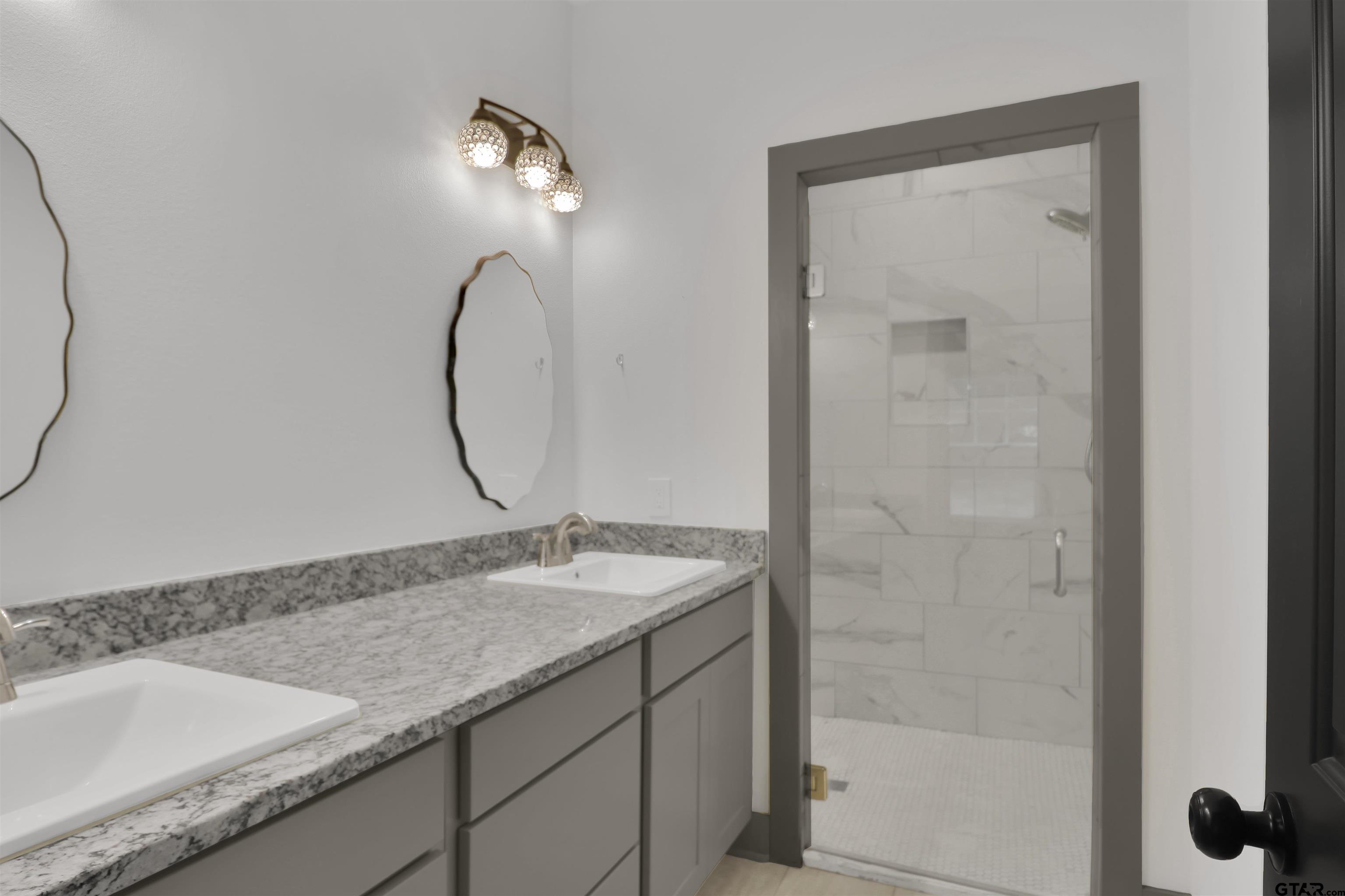 220 Sherman Street Rusk, TX 75785 - Photo 22 of 33 a bathroom with a granite countertop sink and a mirror