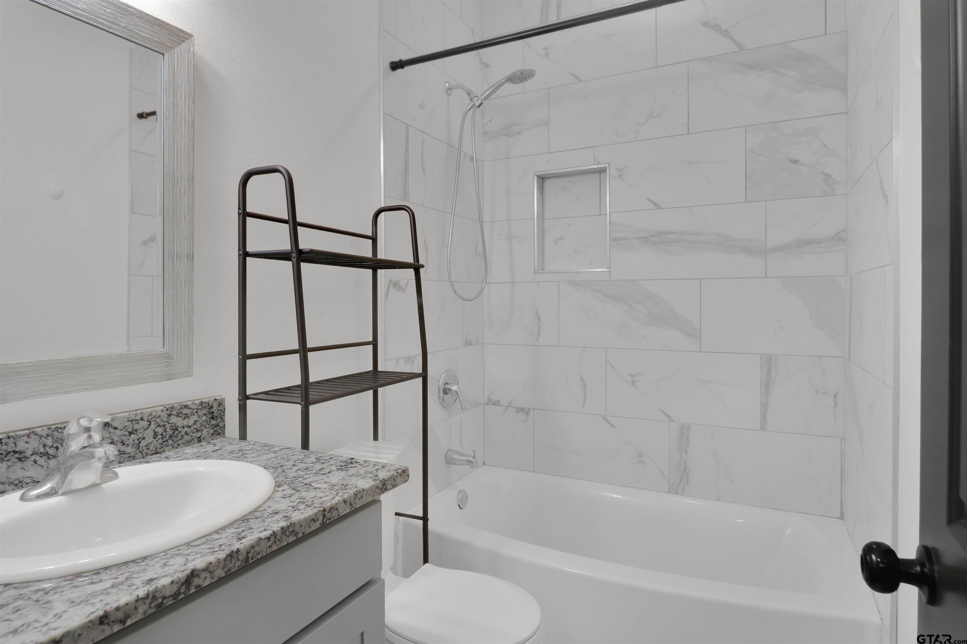 220 Sherman Street Rusk, TX 75785 - Photo 27 of 33 a bathroom with a granite countertop sink toilet and shower
