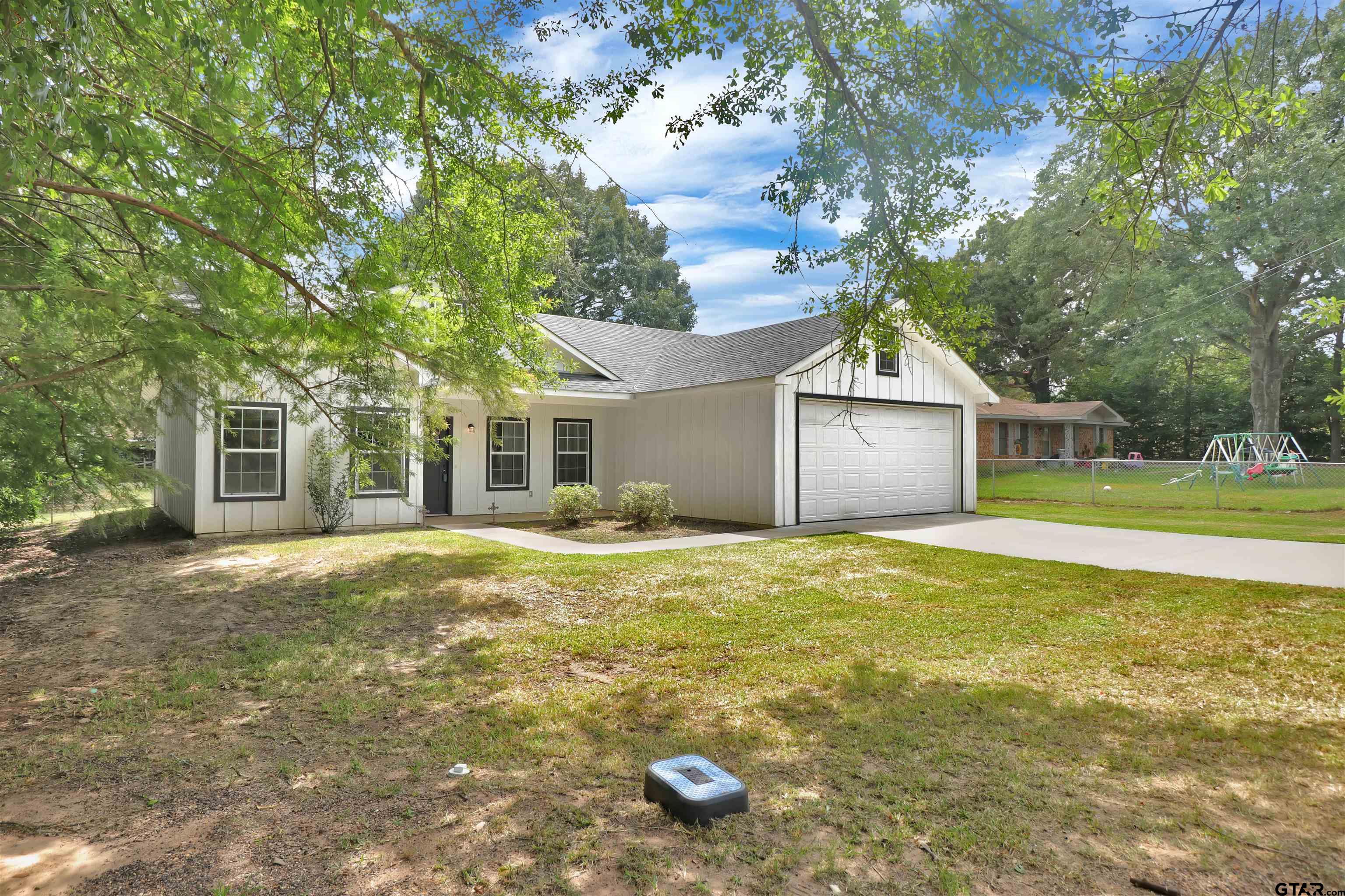 220 Sherman Street Rusk, TX 75785 - Photo 3 of 33 a view of a house with a yard and large tree