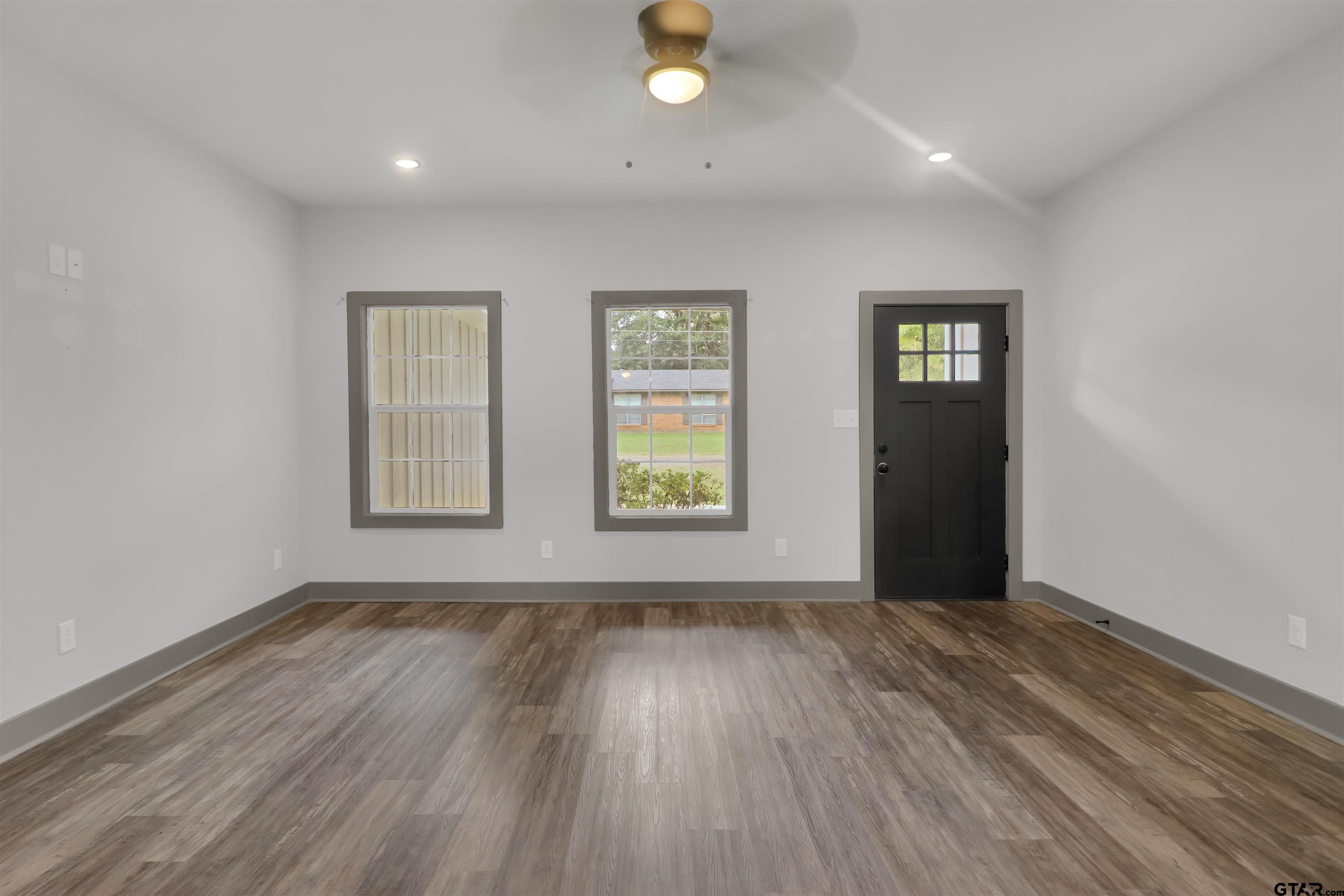 220 Sherman Street Rusk, TX 75785 - Photo 7 of 33 wooden floor in an empty room with a window