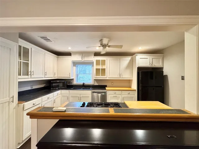 a kitchen with stainless steel appliances granite countertop a sink and cabinets