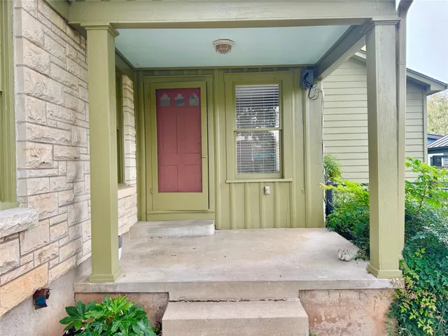 a view of a house with potted plants
