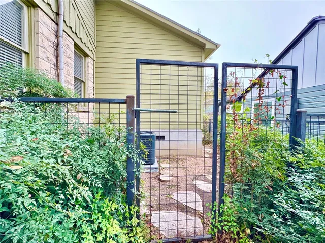a view of empty room with wooden floor and fireplace