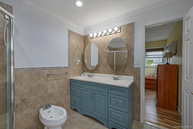 a bathroom with a double vanity sink mirror and toilet